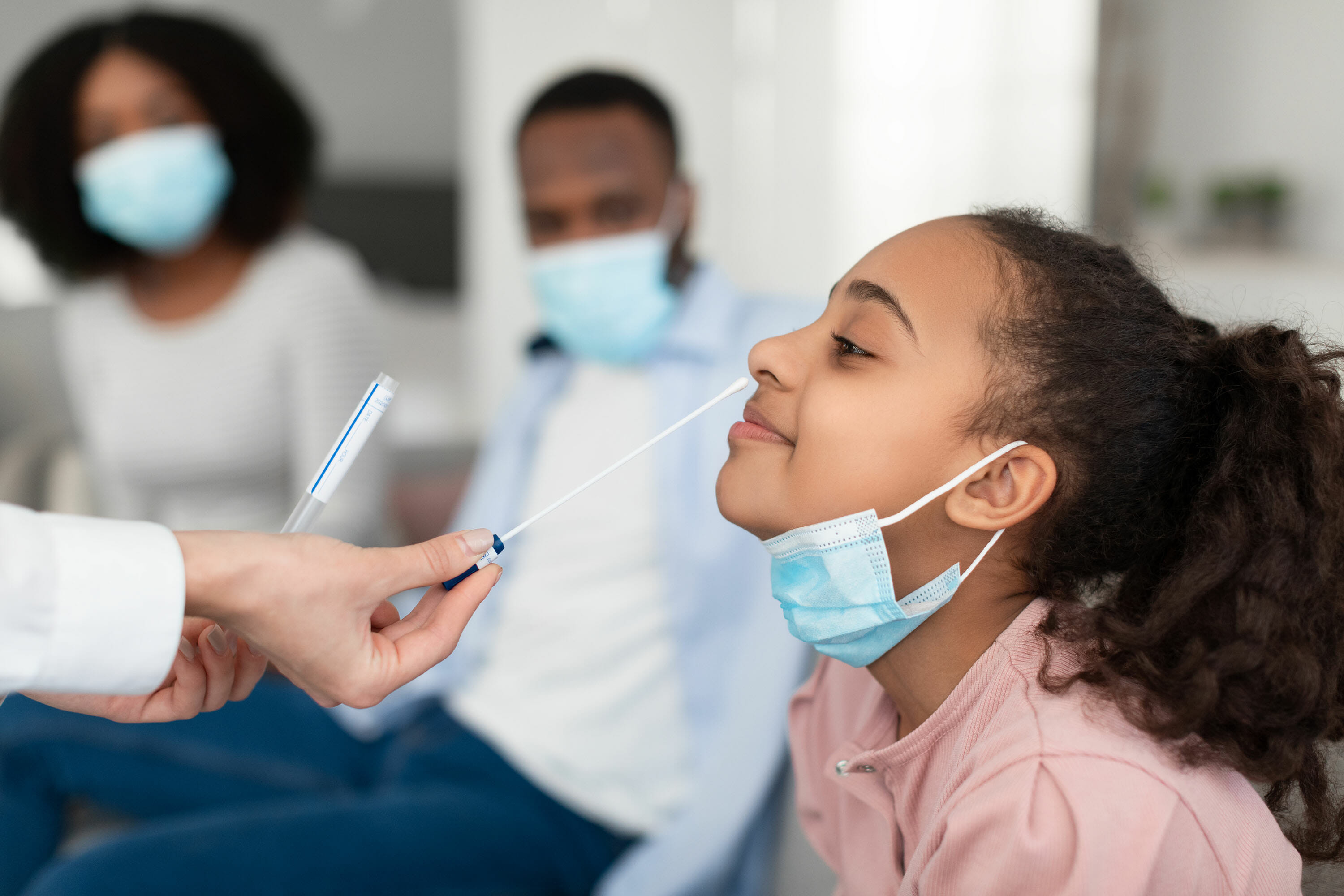Young girl being tested for COVID-19