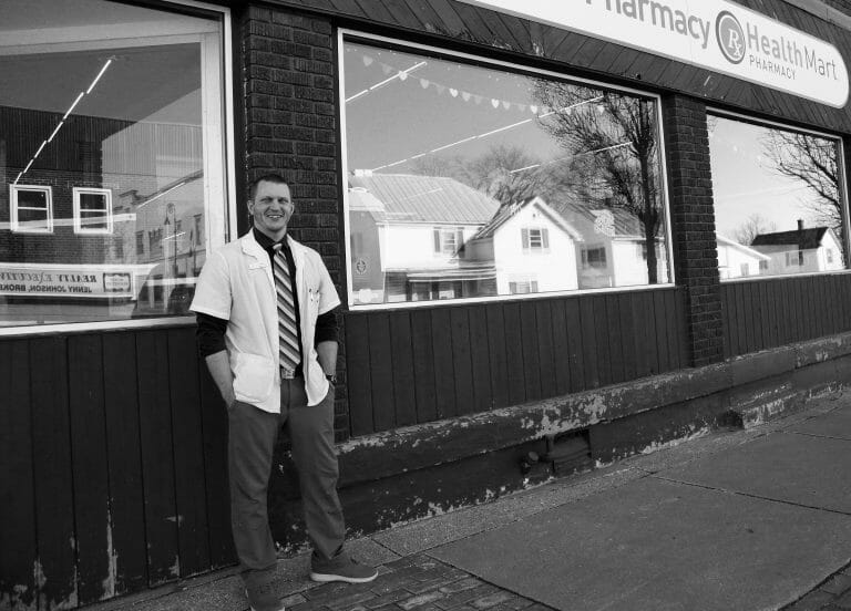 Matt McGowan, full body, standing outside Mt. Horeb Pharmacy, smiling